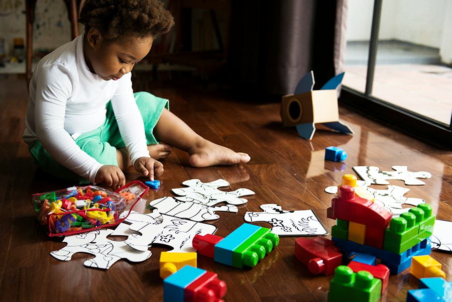 Young boy playing with puzzle pieces