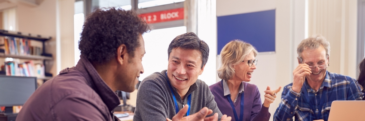 Four adults collaborating in a classroom environment. 