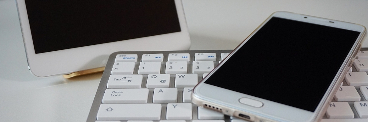 Artfully arranged tablet, smartphone, and wireless keyboard. 