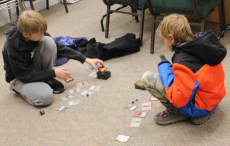 Two children playing Magic: the Gathering card game