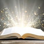 An open book has sparkles and rays of light eminating from its open pages.
