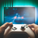 A person's hands hold a video game controller.