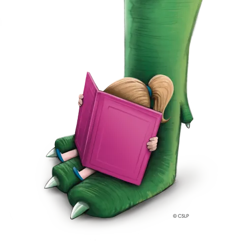 A young reader is sitting with a book that has a pink cover, they are resting on the foot of a large green dinosaur.